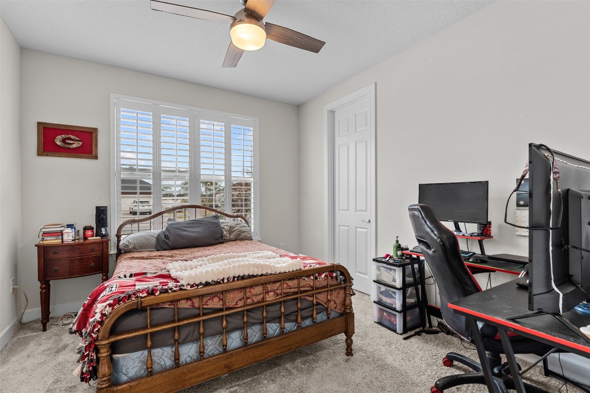93322 Sandown Drive Fernandina Beach, FL 32034 - Photo 30 of 40 a bedroom with a bed and a flat tv screen on the dresser