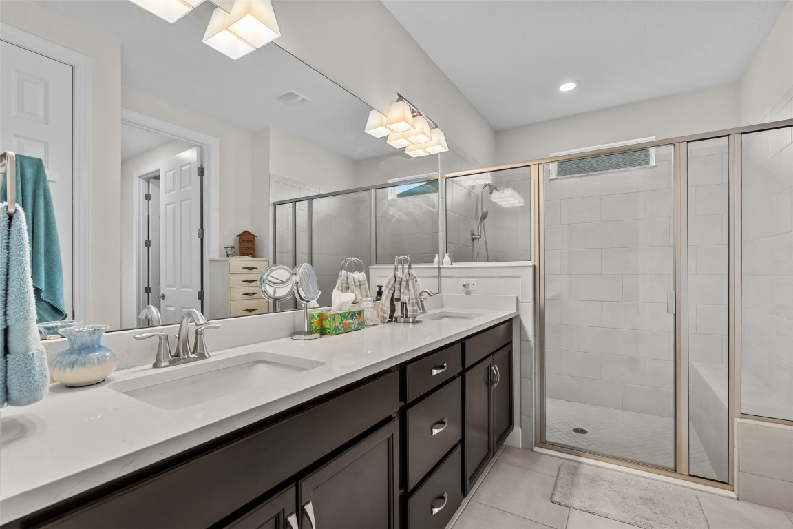 93322 Sandown Drive Fernandina Beach, FL 32034 - Photo 7 of 40 a bathroom with a double vanity sink mirror and shower