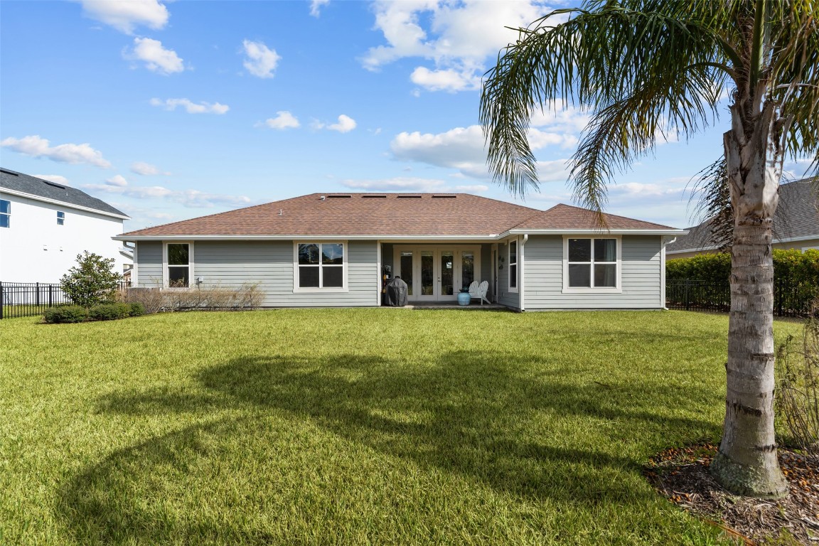 93322 Sandown Drive Fernandina Beach, FL 32034 - Photo 8 of 40 a front view of a house with a garden