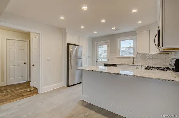a view of a kitchen with a sink and a window