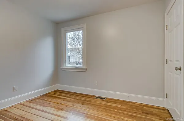 a view of a room with wooden floor and fan