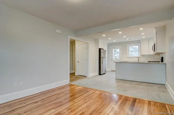 a view of kitchen with wooden floor and electronic appliances
