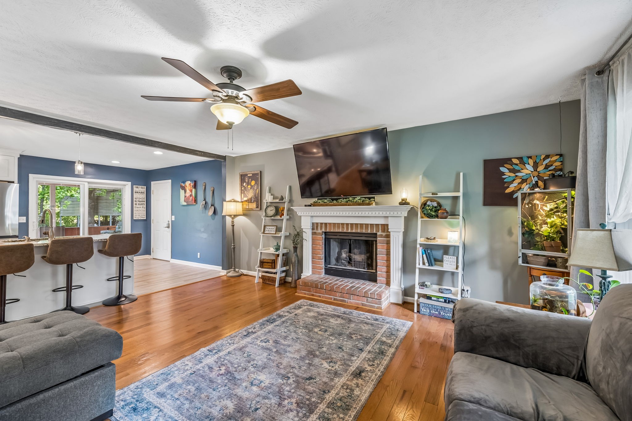 3516 Laurel Court Murfreesboro, TN 37129 - Photo 8 of 65 a living room with furniture a flat screen tv and a fireplace