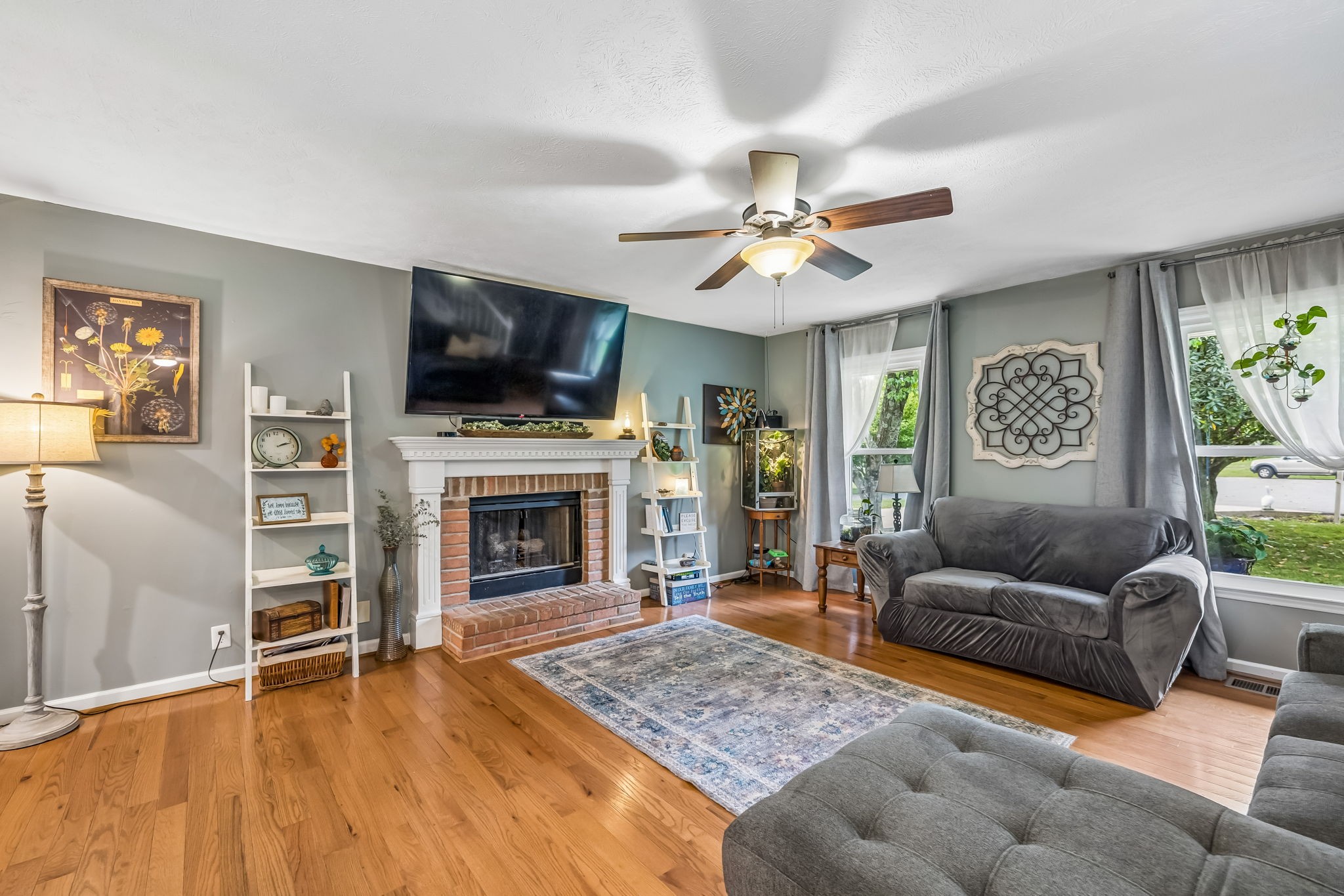 3516 Laurel Court Murfreesboro, TN 37129 - Photo 10 of 65 a living room with furniture a flat screen tv and a fireplace