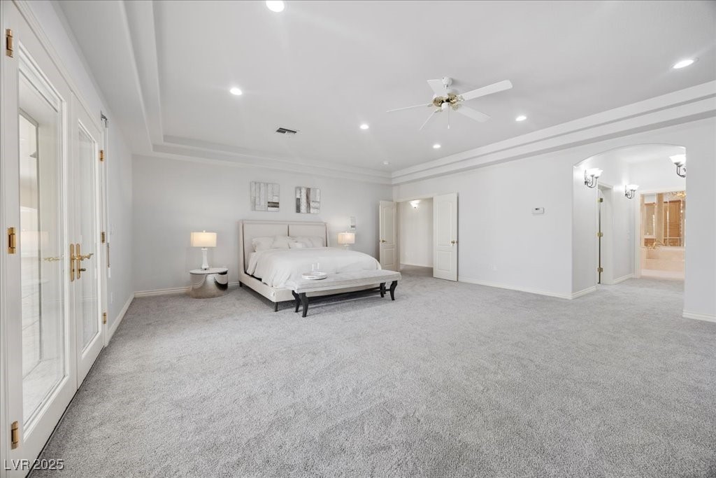 640 Quail Covey Road Henderson, NV 89002 - Photo 12 of 75 Carpeted bedroom with arched walkways, recessed lighting, ornamental molding, connected bathroom, and ceiling fan