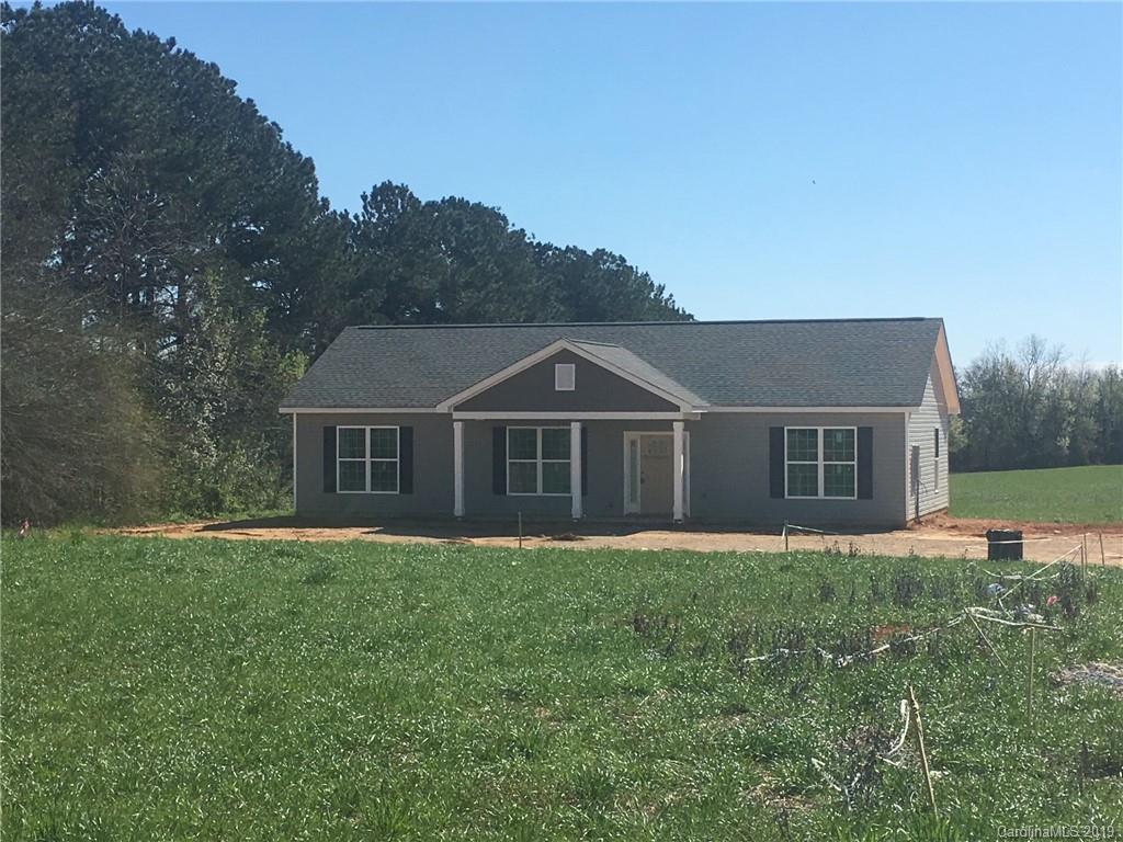 8511 Landsford Road Monroe, NC 28112 - Photo 1 of 1 a front view of house with yard and trees in the background