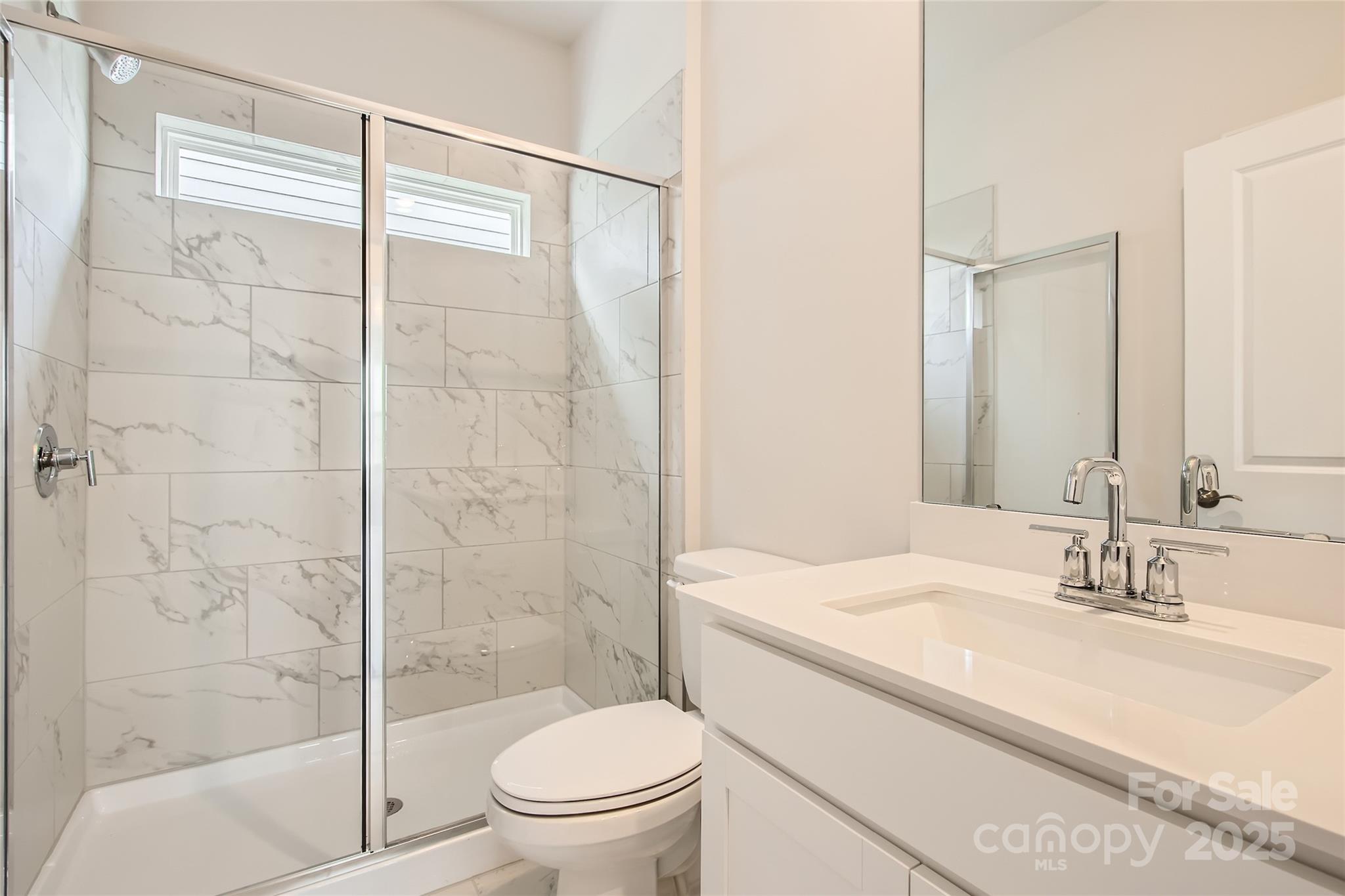 8473 Norman Frst Road Lancaster, SC 29720 - Photo 11 of 18 a bathroom with a sink toilet and shower