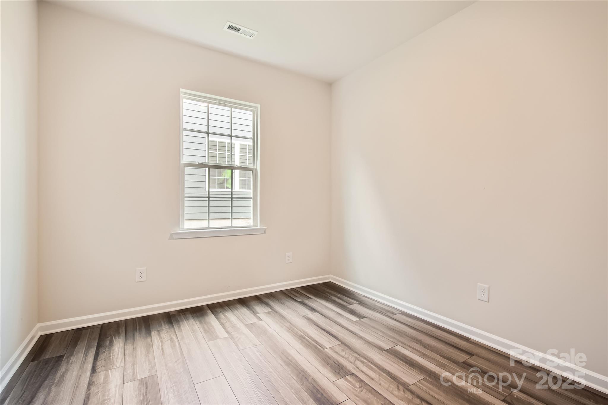 8473 Norman Frst Road Lancaster, SC 29720 - Photo 12 of 18 an empty room with wooden floor and windows