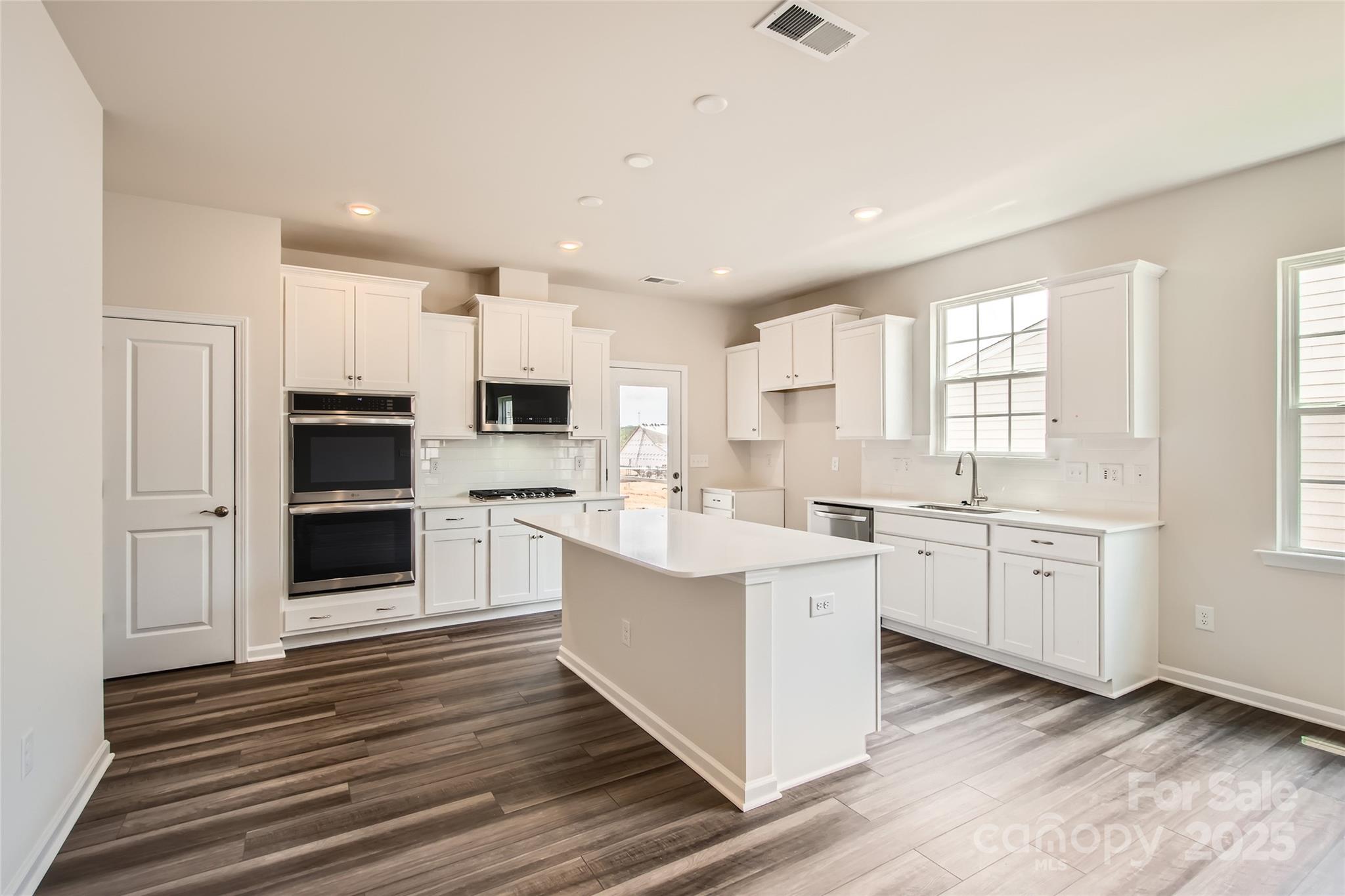 8473 Norman Frst Road Lancaster, SC 29720 - Photo 6 of 18 a kitchen with white cabinets and appliances