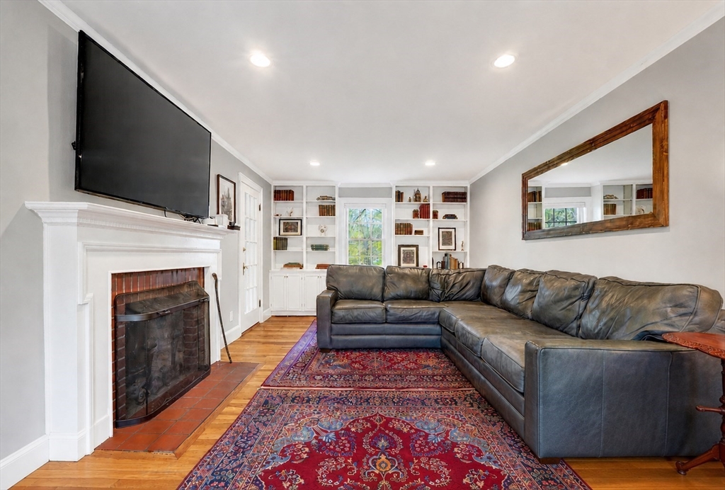 87 Payson Road Brookline, MA 02467 - Photo 5 of 41 a living room with furniture a flat screen tv and a fireplace