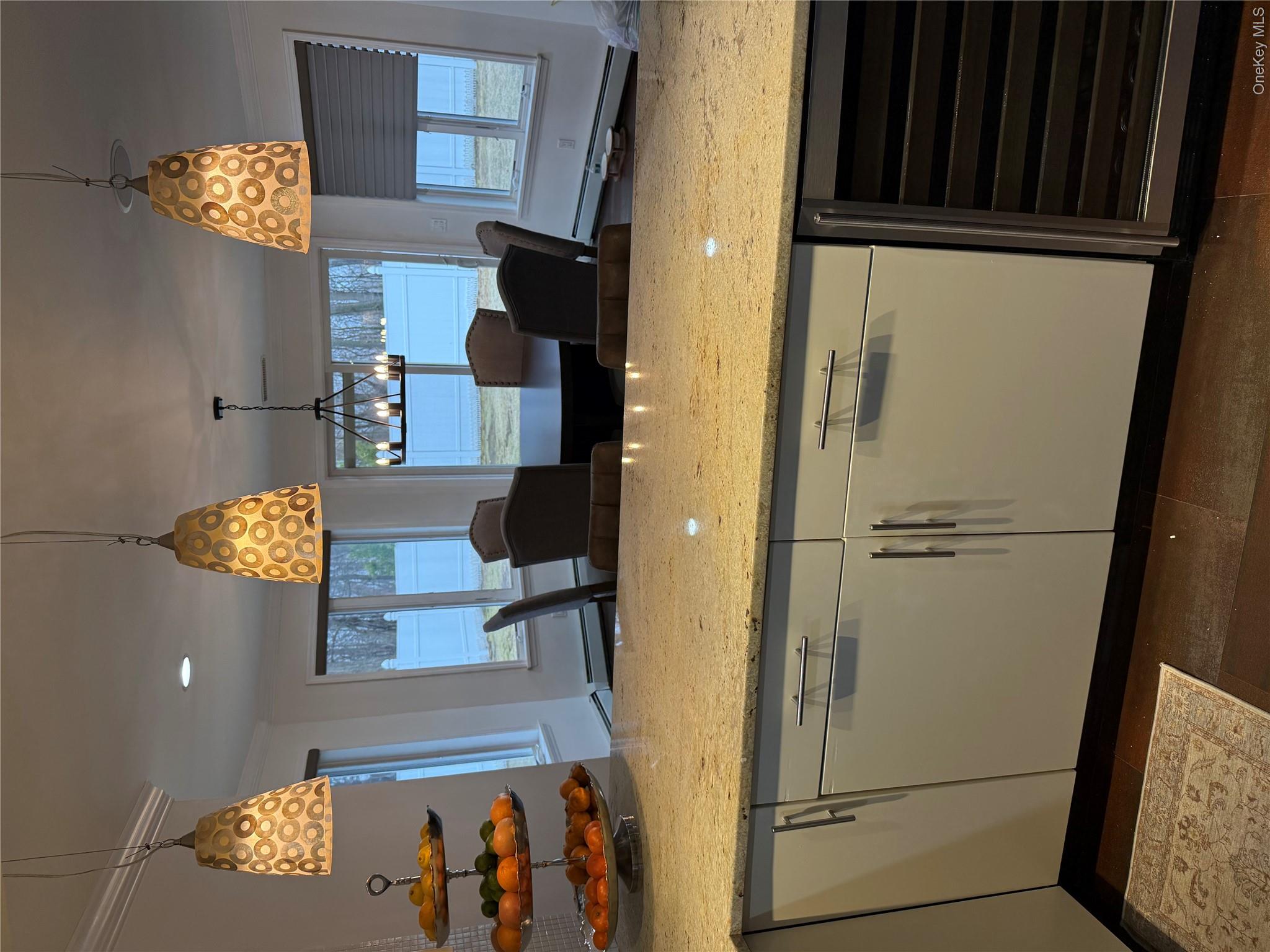 29 Wilton Road Rye Brook, NY 10573 - Photo 4 of 18 Kitchen with wine cooler, white cabinets, pendant lighting, and light stone countertops