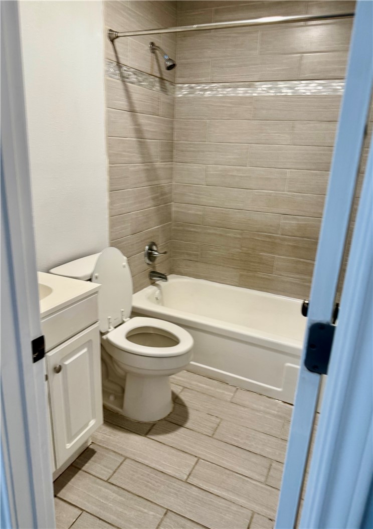 105-107 Davis Street Bryan, TX 77801 - Photo 12 of 14 a bathroom with a toilet and a shower