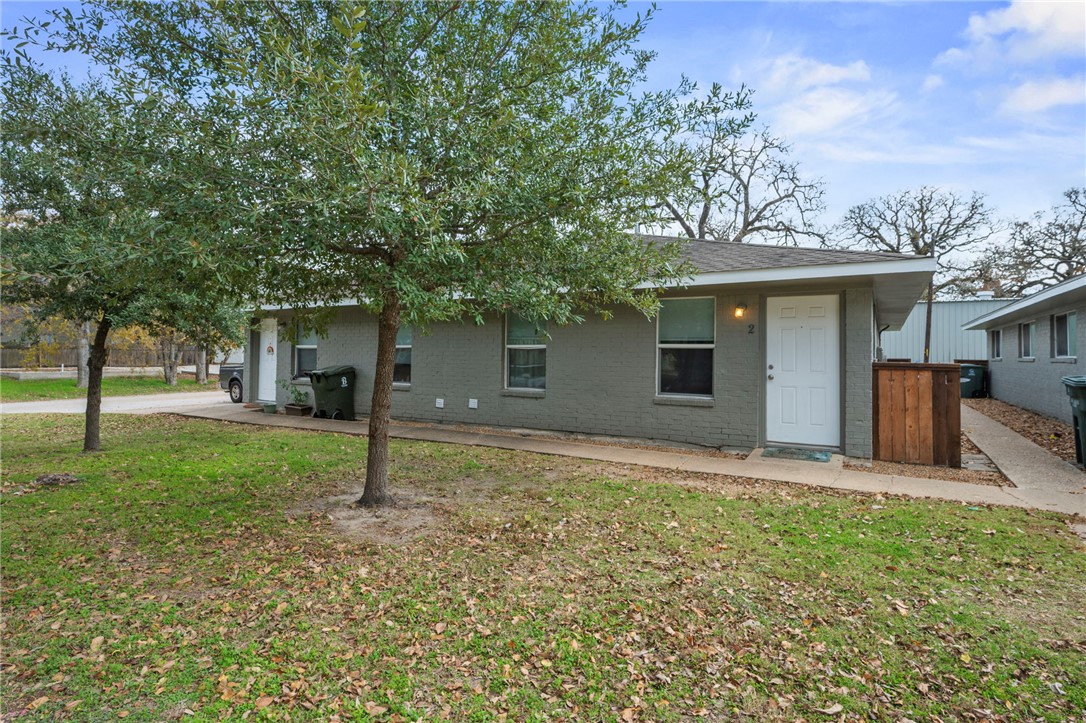 105-107 Davis Street Bryan, TX 77801 - Photo 3 of 14 front view of a house with a yard