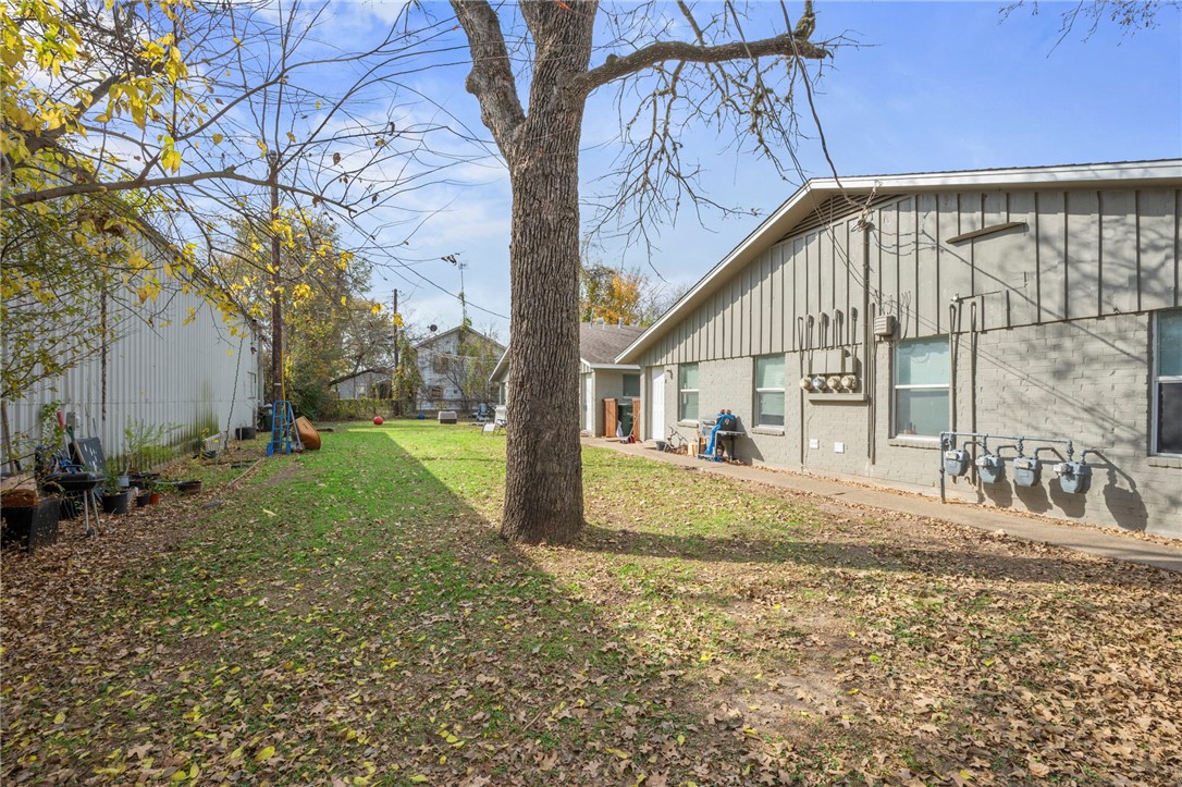 105-107 Davis Street Bryan, TX 77801 - Photo 6 of 14 a view of a house with backyard and tree