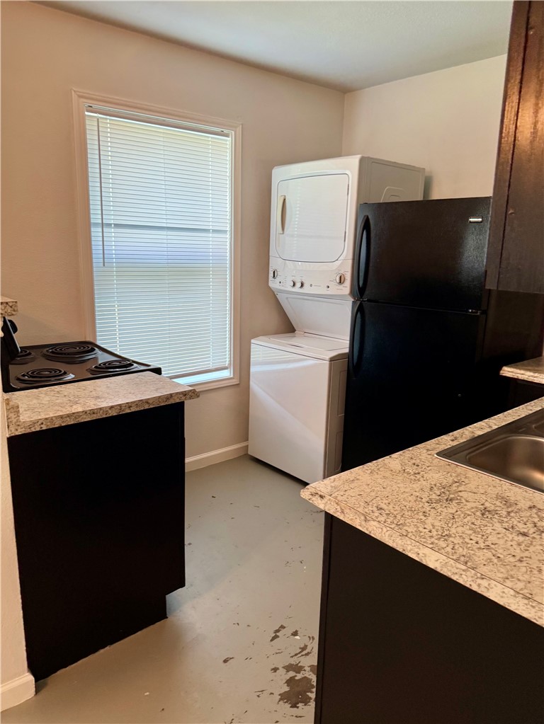 105-107 Davis Street Bryan, TX 77801 - Photo 10 of 14 a kitchen with a sink and a refrigerator