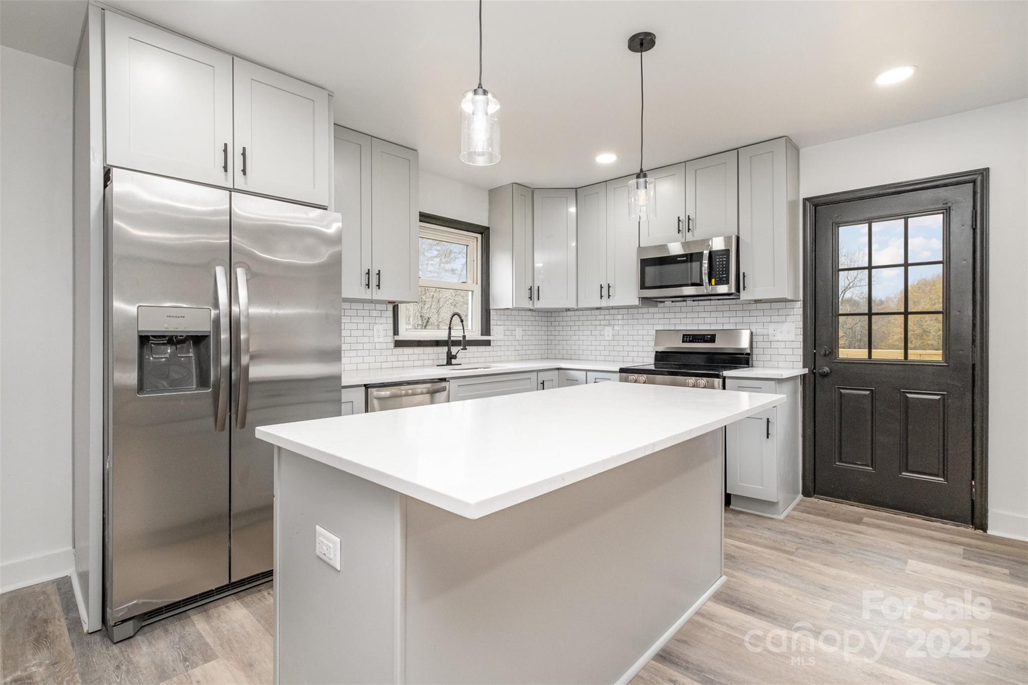 5674 Alan D Good Lane Conover, NC 28613 - Photo 9 of 21 a kitchen with kitchen island white cabinets and refrigerator