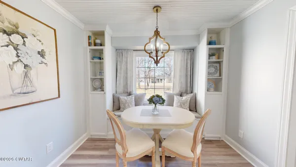 a dining room with furniture and window