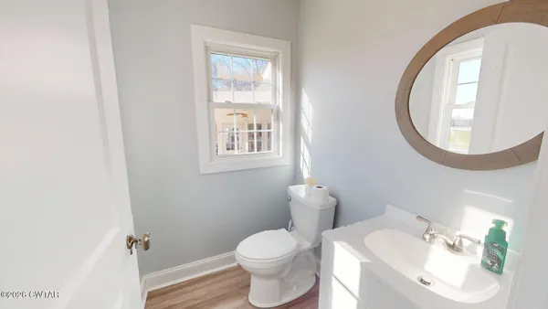a white toilet sitting next to a bathroom sink