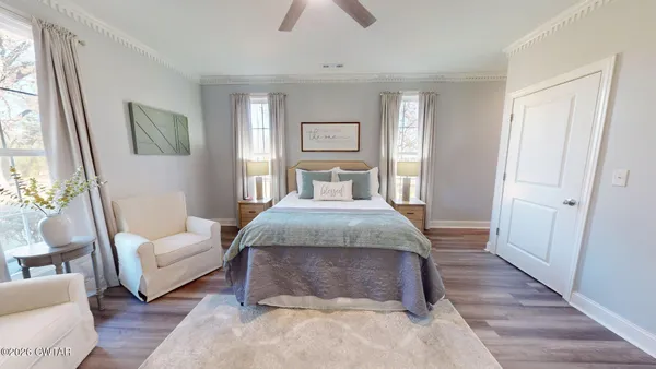 a bedroom with a large bed and a couch