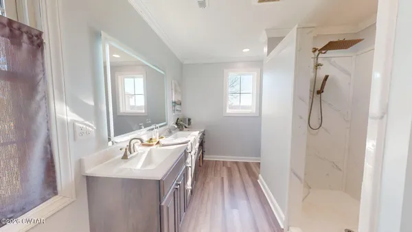 a bathroom with a sink a toilet and shower