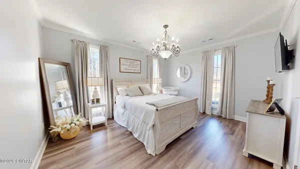 a room with a bed mirror and window