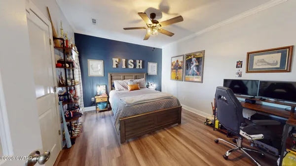 a bedroom with a bed and a chandelier