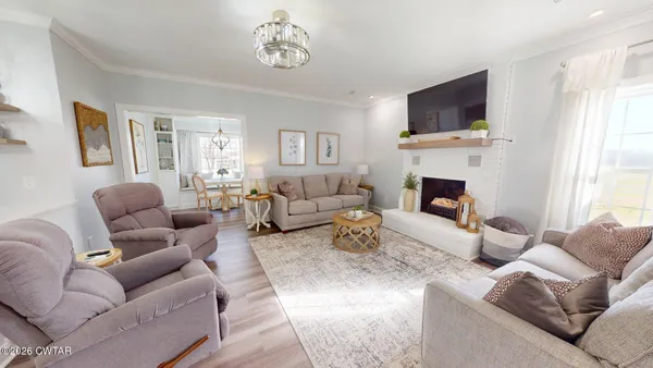 a living room with furniture fireplace and a flat screen tv
