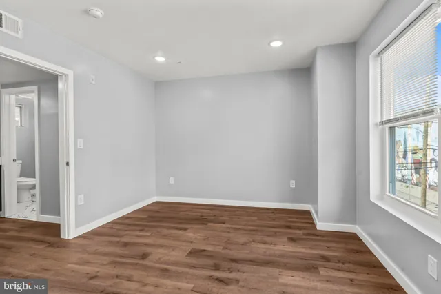 wooden floor in an empty room with a window