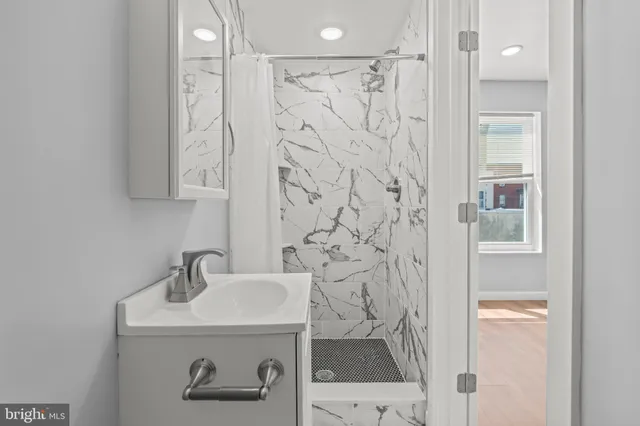 a bathroom with a sink and mirror