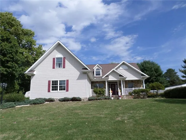 a front view of a house with a garden