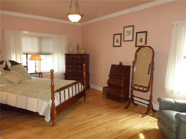 a bed room with a bed and a chair