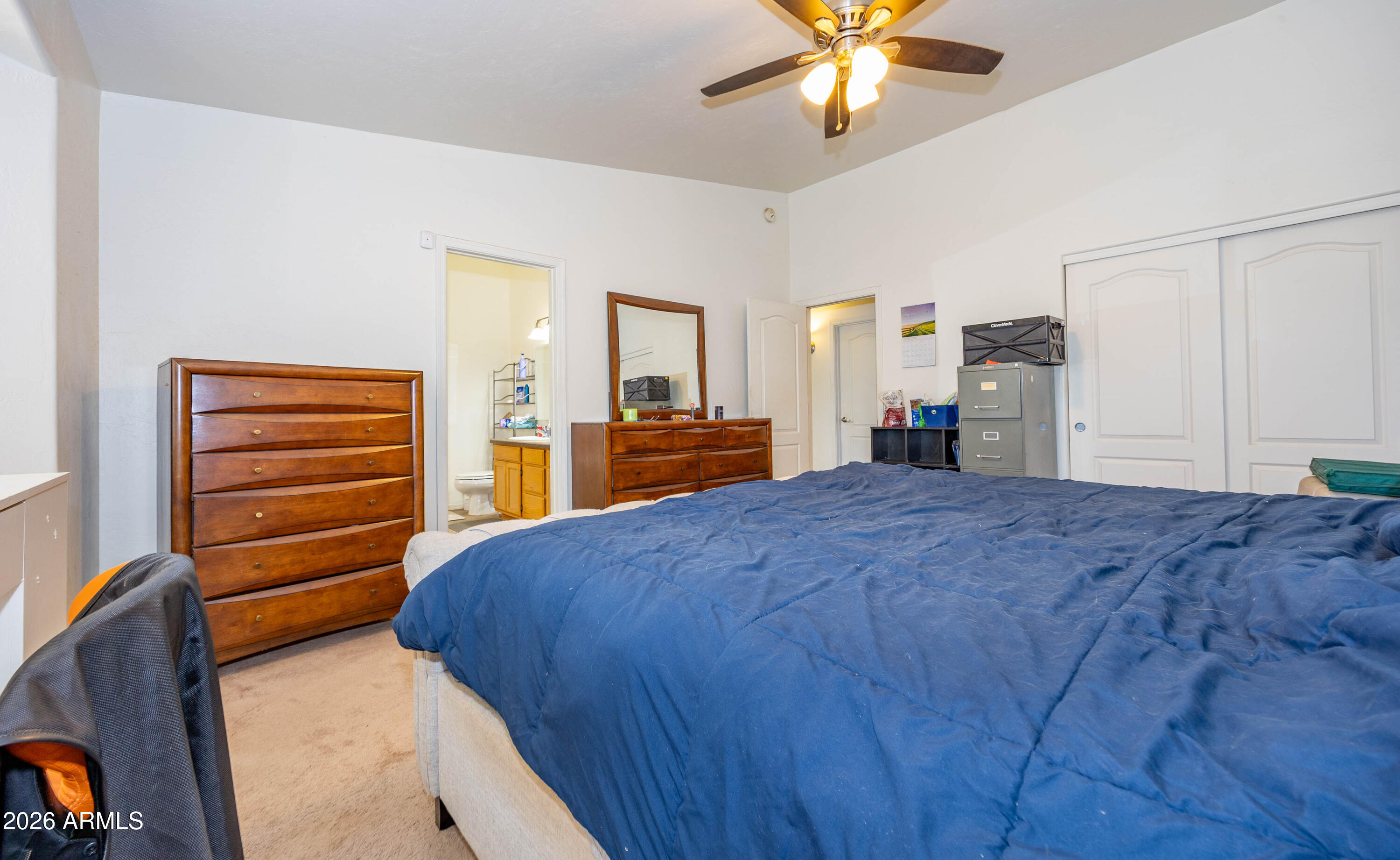 4575 South Kino Road Sierra Vista, AZ 85650 - Photo 21 of 25 a bedroom with a bed and a chandelier