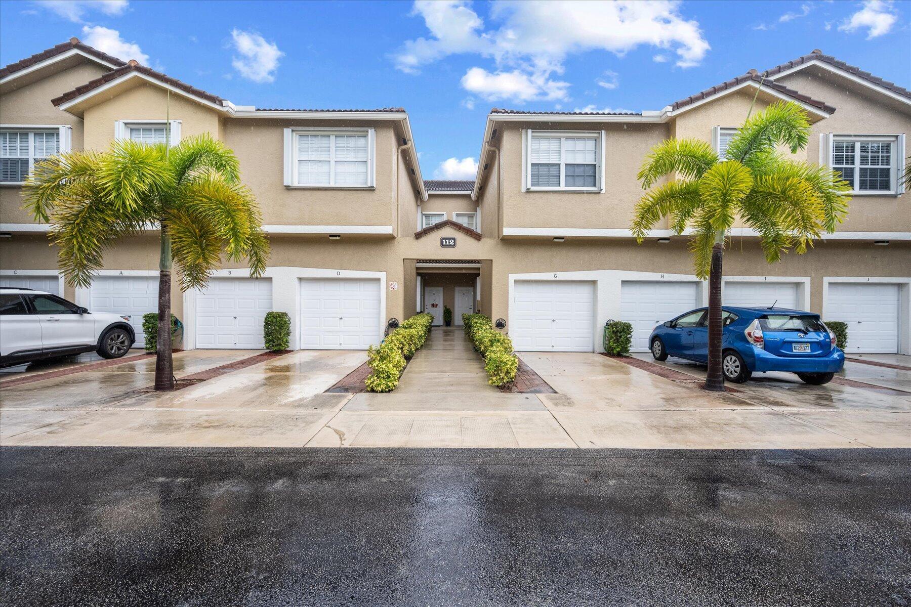 112 Lighthouse Circle, Unit G Tequesta, FL 33469 - Photo 1 of 27 a front view of a house with garden