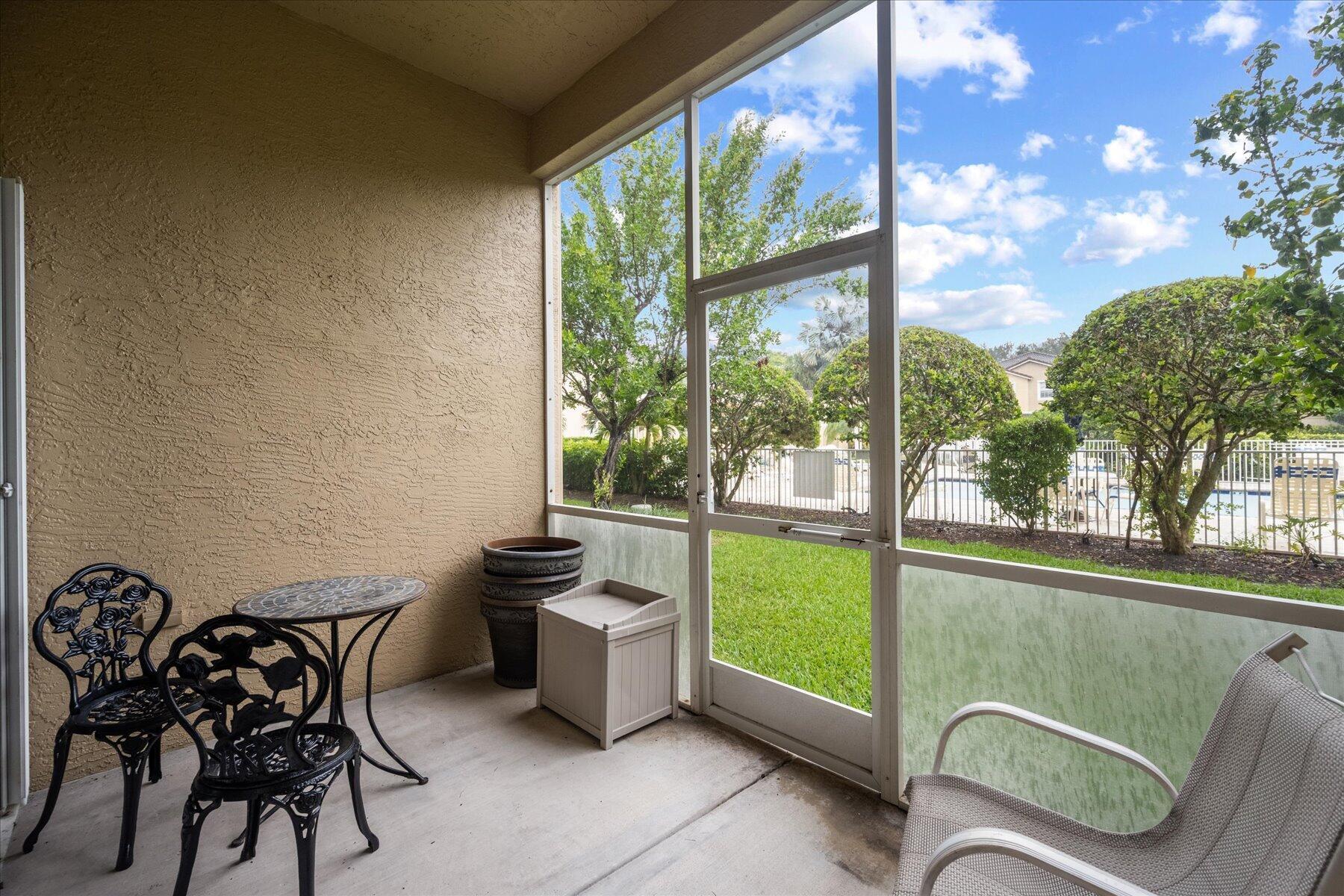 112 Lighthouse Circle, Unit G Tequesta, FL 33469 - Photo 11 of 27 a view of a chairs and table in patio