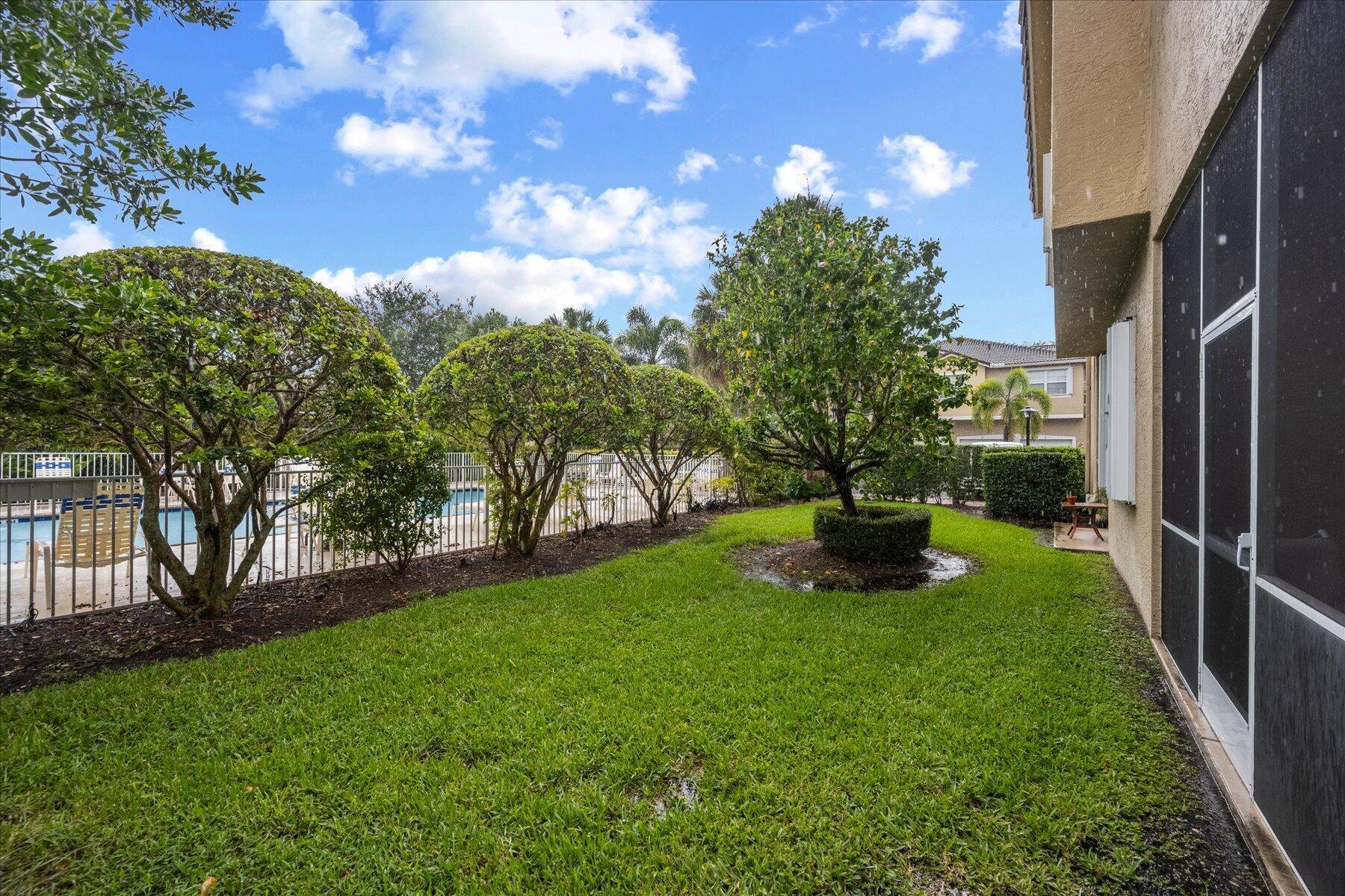 112 Lighthouse Circle, Unit G Tequesta, FL 33469 - Photo 12 of 27 a view of a garden with a fountain