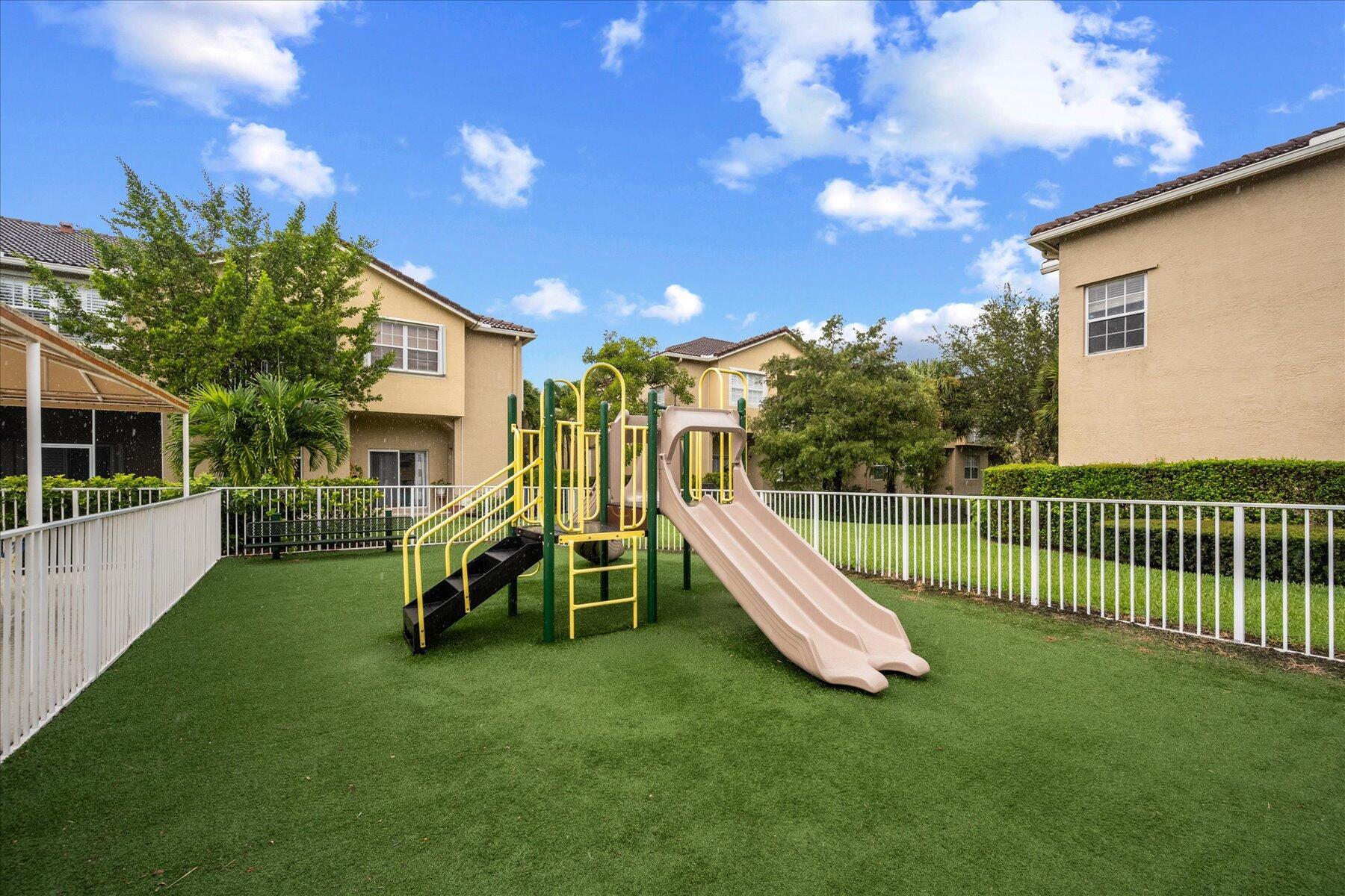 112 Lighthouse Circle, Unit G Tequesta, FL 33469 - Photo 13 of 27 a view of a house with a backyard
