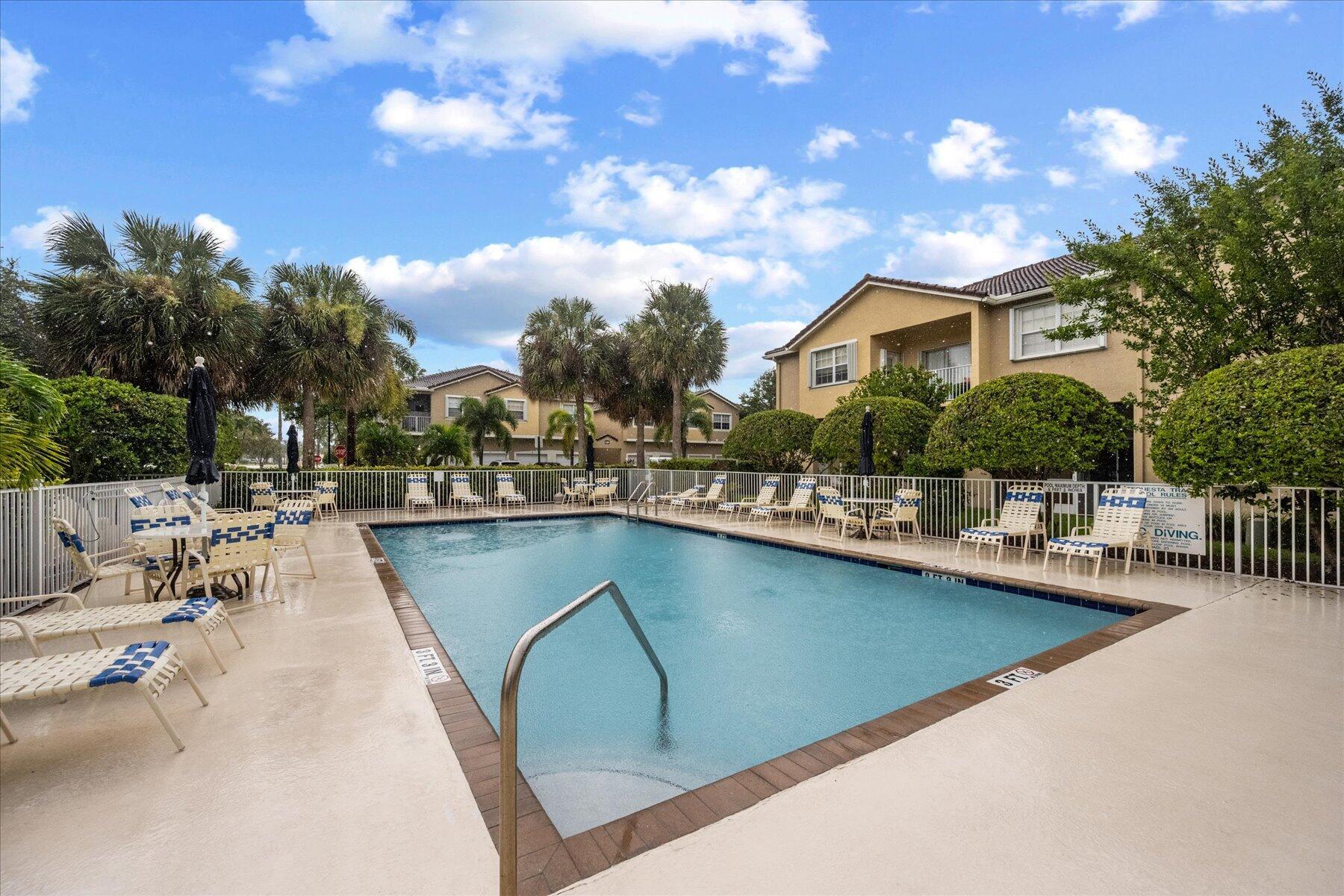 112 Lighthouse Circle, Unit G Tequesta, FL 33469 - Photo 14 of 27 a view of a swimming pool with outdoor seating