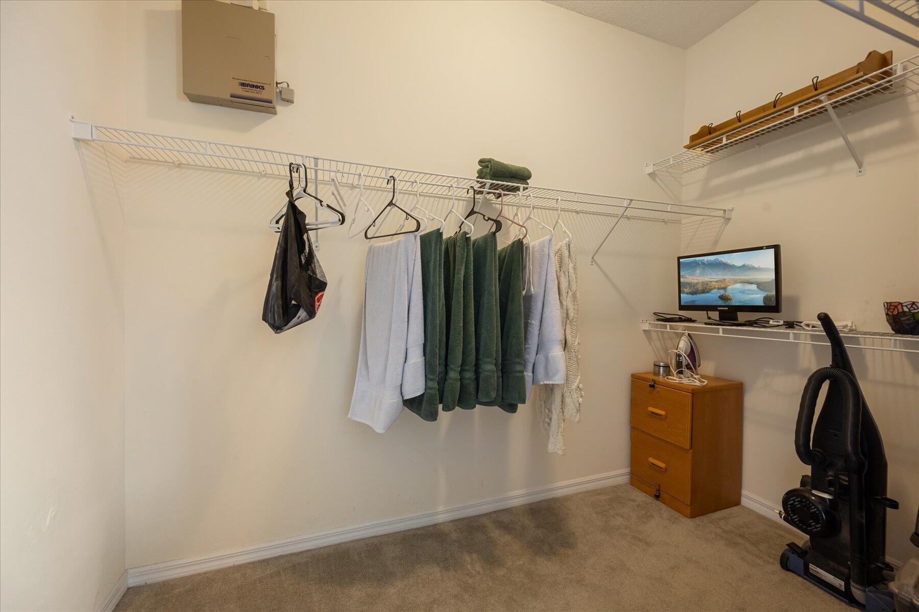 112 Lighthouse Circle, Unit G Tequesta, FL 33469 - Photo 19 of 27 a view of walk in closet with clothes
