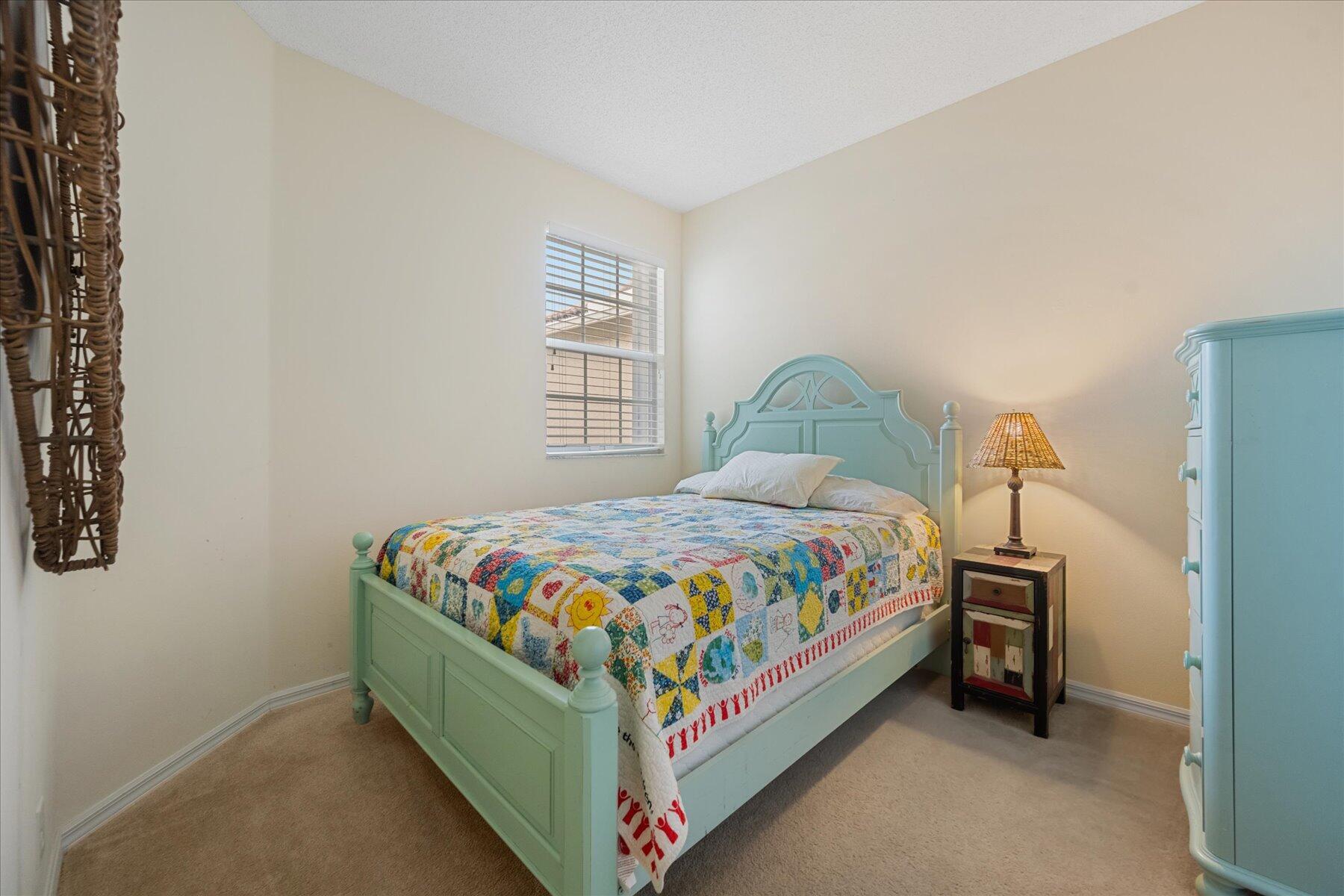 112 Lighthouse Circle, Unit G Tequesta, FL 33469 - Photo 20 of 27 a bedroom with a bed and a window