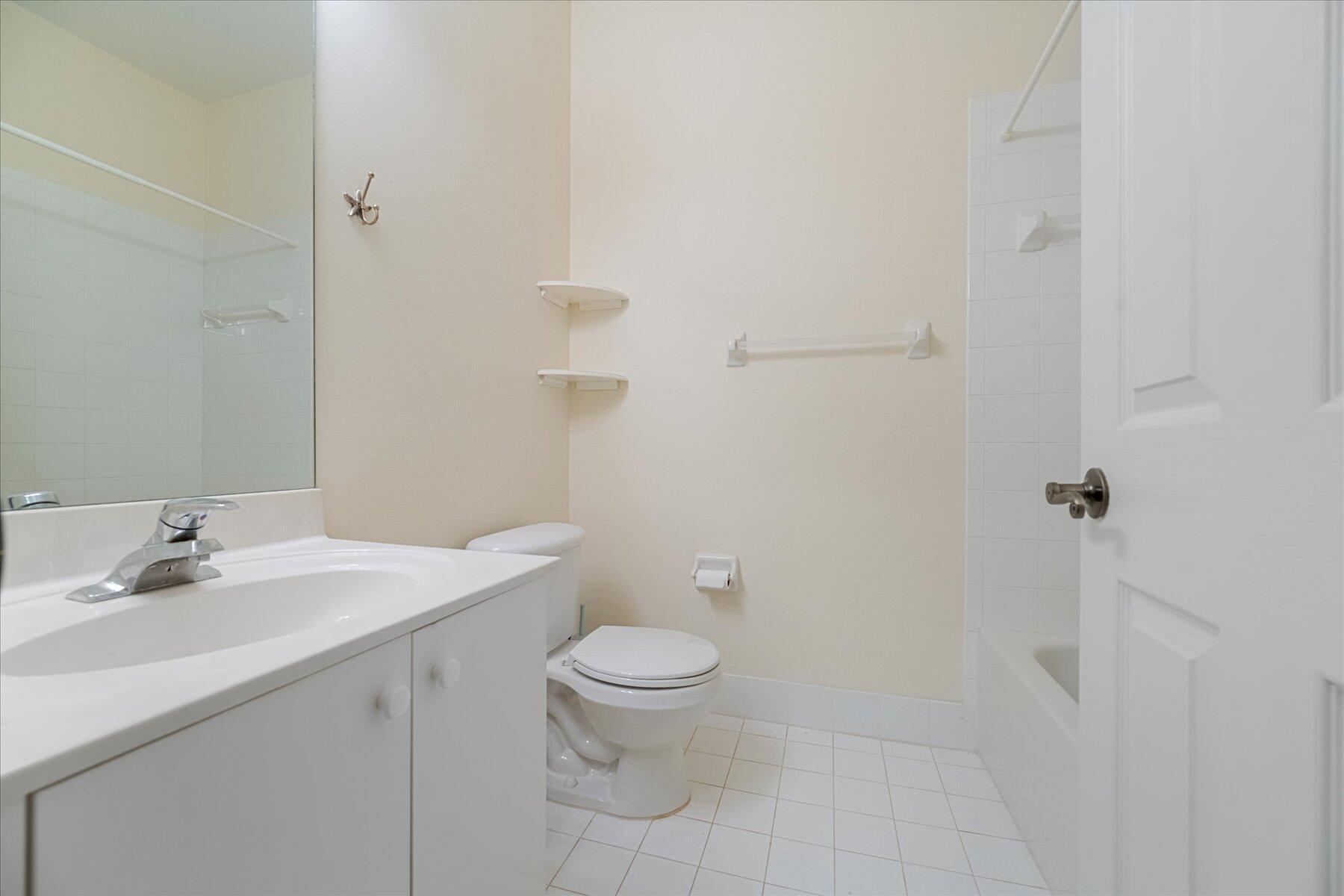 112 Lighthouse Circle, Unit G Tequesta, FL 33469 - Photo 21 of 27 a bathroom with a sink toilet and vanity