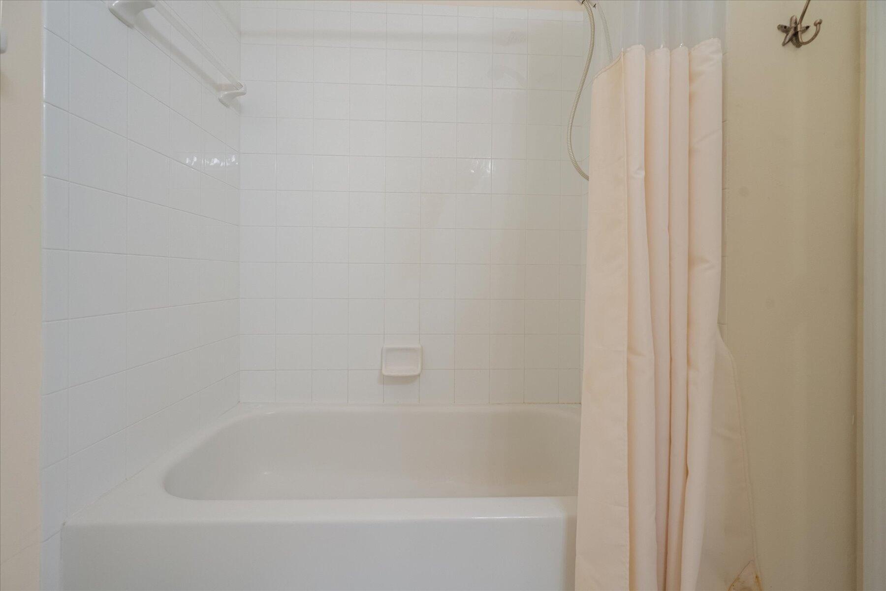 112 Lighthouse Circle, Unit G Tequesta, FL 33469 - Photo 22 of 27 a close up of a bathtub with a shower