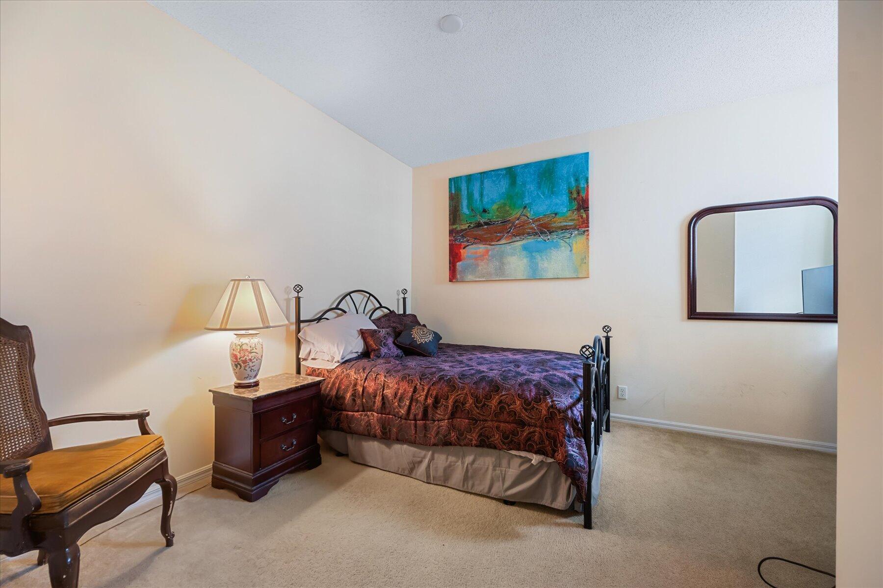 112 Lighthouse Circle, Unit G Tequesta, FL 33469 - Photo 23 of 27 a bedroom with a bed and a couch