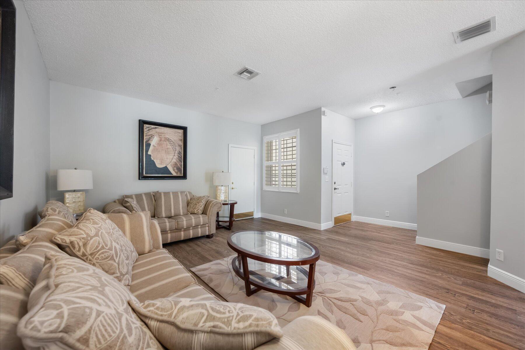 112 Lighthouse Circle, Unit G Tequesta, FL 33469 - Photo 5 of 27 a living room with furniture and a window