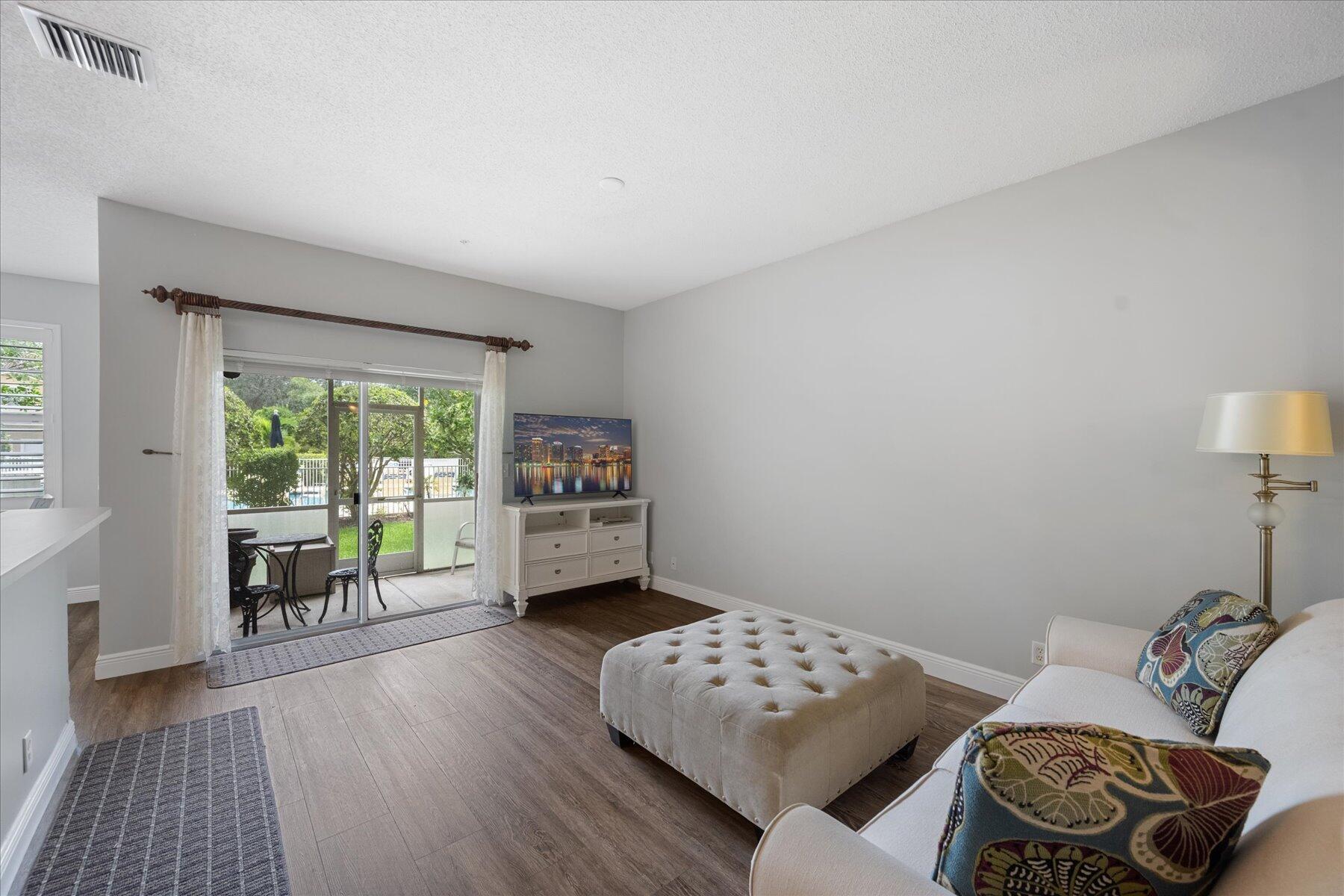 112 Lighthouse Circle, Unit G Tequesta, FL 33469 - Photo 6 of 27 a living room with furniture and a window