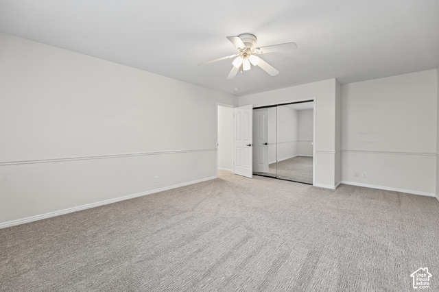 10664 Trail Ridge Circle Sandy, UT 84092 - Photo 40 of 113 Neutral wall finishes, textured carpeting, mirrored closet doors, ceiling fan, and white paneled door