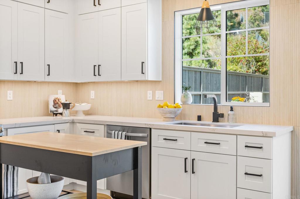 1653 Reflection Street San Marcos, CA 92078 - Photo 23 of 68 a kitchen with a sink window and cabinets