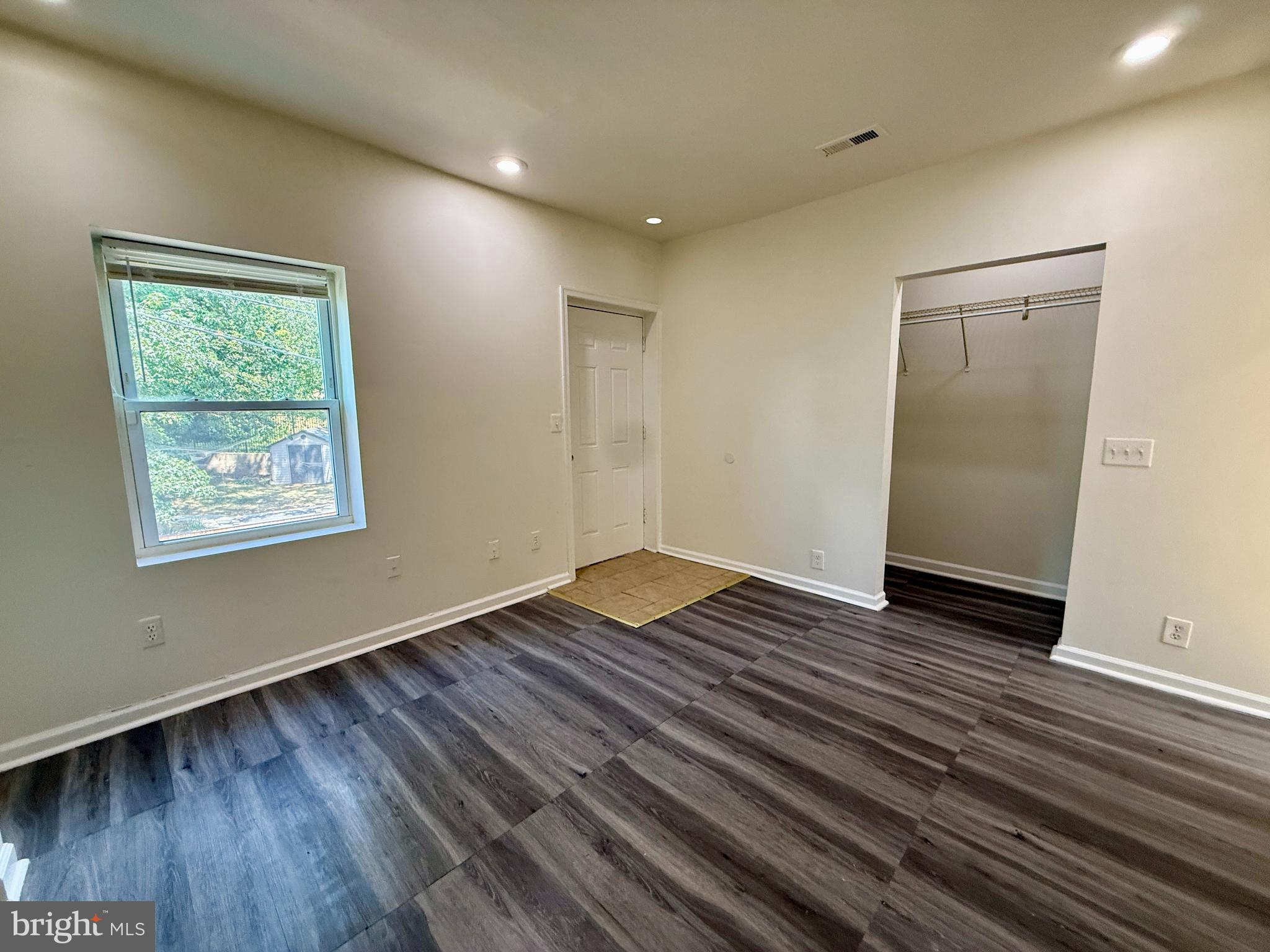1908 M Street Northeast Washington, DC 20002 - Photo 11 of 20 a view of an empty room with wooden floor and a window