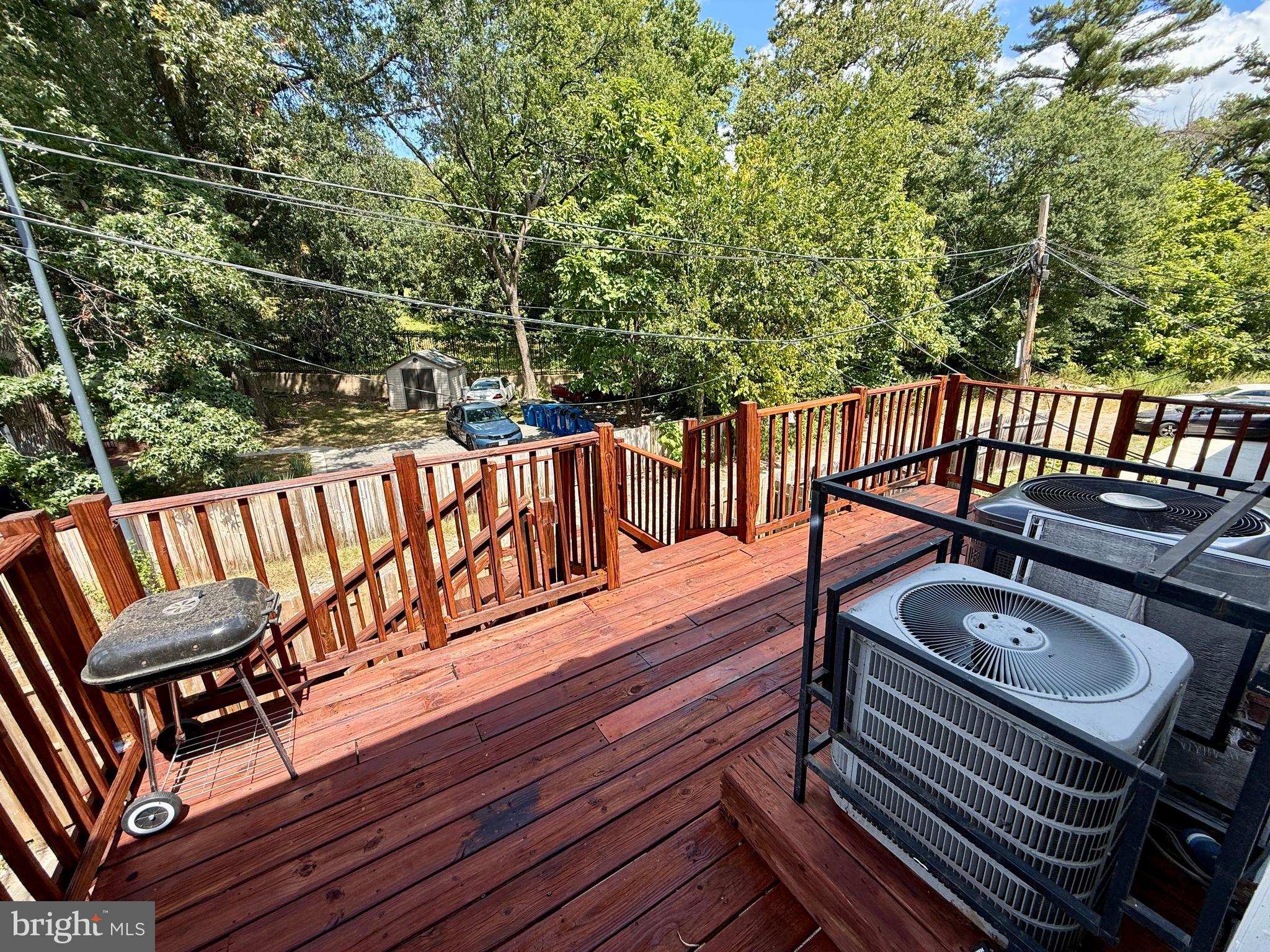 1908 M Street Northeast Washington, DC 20002 - Photo 14 of 20 a balcony with wooden floor outdoor seating and yard in the back