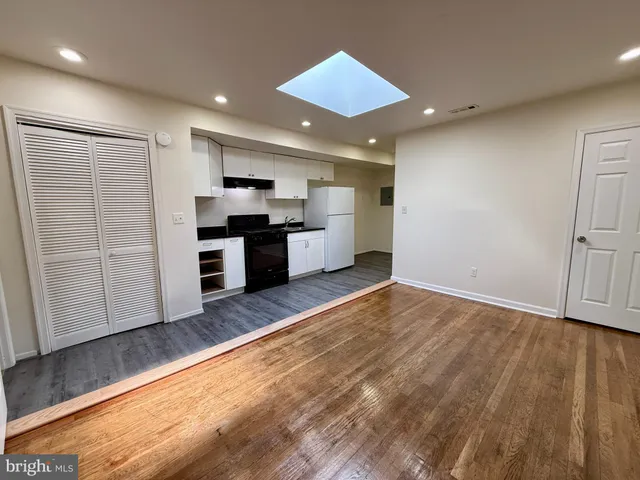 a large kitchen with stainless steel appliances granite countertop a stove and a refrigerator