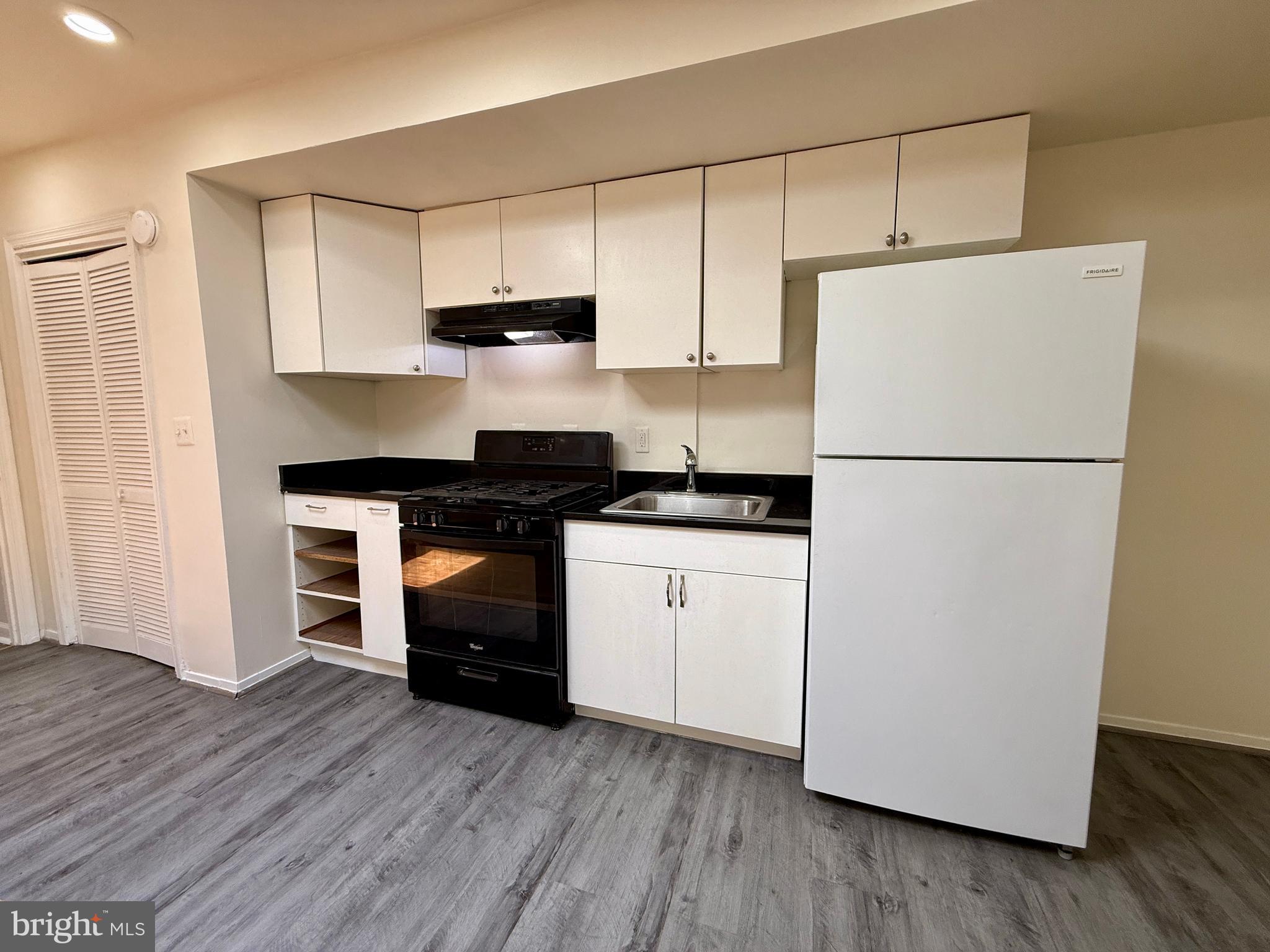 1908 M Street Northeast Washington, DC 20002 - Photo 5 of 20 a kitchen with a refrigerator and a stove top oven